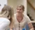 Female student in cream colored dress engaged in conversation