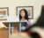 Female student standing at podium with computer