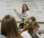 Social work professor points to writing on the board during a lecture