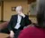 Political science professor sits in thoughtful discussion with others