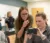Three female students read results from lab equipment