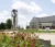 A view of Dordt's clocktower and campus center with flowers in the foreground.