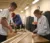 Engineering students measure some wood for a project