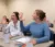 Students raise their hands to answer a question in class