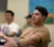 Male student sits in class and participates as he talks with his hands