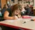 A child colors a picture in class