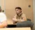A male student sits listening in class