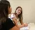 Two female students interact in a classroom