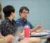A male student gestures as he speaks in class