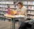 A female student works on her laptop in the library