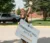 A picture of a student weaving and holding a move in sign during week of welcome