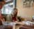 a girl sits at a table and reviews a paper