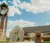 A picture of Dordt's clocktower and campus center on a sunny day with big white clouds in the background.
