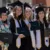 a group of female graduates smile for the camera after commencement