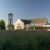 Campus Center building and clocktower in early morning with tallgrasses in the foreground