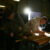 Two engineers measure and cut some wood
