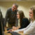 professor looking at a joyful student's computer screen