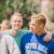 Male student smiles at the camera while with his friend