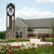 A picture of Dordt's campus with some red and yellow prairie flowers in front of it.