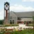 A picture of Dordt's campus with some red and yellow prairie flowers in front of it.
