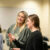two female students discuss with each other in class