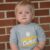 A picture of a child wearing a "Dordt's cutest lil' Defender" shirt