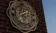 A picture of the old Dordt College seal on a brick structure.