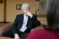 Political science professor sits in thoughtful discussion with others