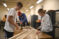 Engineering students measure some wood for a project