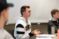 Male student participates in his class, gesturing with his hands as he talks