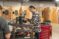 A student works at a piece of equipment in the manufacturing lab