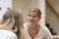 Female student in cream colored dress engaged in conversation