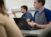 A student points as he participates in a classroom discussion
