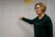 female professor points to work on the whiteboard