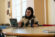 student presents to table using her mac laptop in the grille area