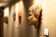 A stone face hung up on the wall of the art exhibit