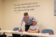Professor leans over student and explains assignment