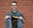 A picture of Daniel Seaman holding a week of welcome jacket