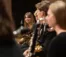A musician smiles at fellow musicians
