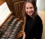 headshot of woman sitting at piano