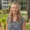 Smiling young, blond woman standing outside