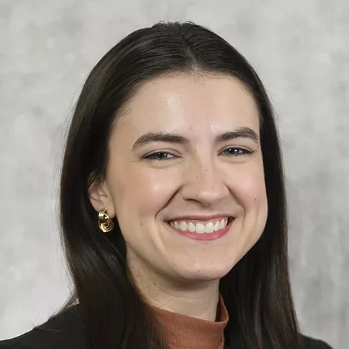 Smiling young lady with straight dark hair